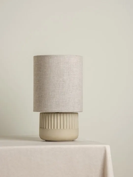 Enza - warm white ribbed concrete table lamp